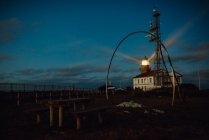 Road and lighthouse in evening — Stock Photo