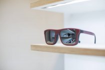 Sunglasses on a shelf in a store — Stock Photo