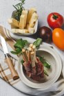 Gressini con tipico prosciutto serrano spagnolo in pentola con formaggio e pomodori freschi su fondo bianco — Foto stock