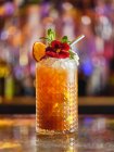 Cocktail decorated with fruits and flower — Stock Photo