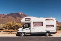 Camper van parked on asphalt road near picturesque view of blue heaven and mountain Teide in Tenerife, Canary Islands, Spain — Stock Photo