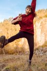 Jovem hipster mulher com upped mão ouvir música no celular e dançar na natureza — Fotografia de Stock
