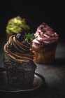 Delicious homemade cupcakes on dark background — Stock Photo