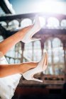 Pernas de corte de jovem mulher elegante em vestido de noiva e saltos altos perto de edifício retro em dia ensolarado — Fotografia de Stock