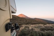 Camper van on land near picturesque peak of mountain Teide at sunset in Tenerife, Canary Islands, Spain — Stock Photo