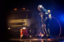 Muscular firefighter on mission — Stock Photo
