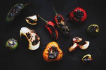Жареные овощи, разбросанные на черном фоне — стоковое фото