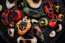 Close-up of delicious roasted vegetables on black tray — Stock Photo