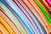 Multicolored brush strokes of acrylic colors on white canvas — Stock Photo