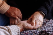 Detail of the wrinkled hands of an elderly couple — Stock Photo