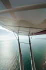 Vista aérea del mar y el ala avión pequeño - foto de stock