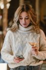 Stylish woman drinking wine in bar — Stock Photo