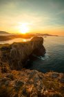Vista panorâmica de enormes penhascos rochosos acima da água ondulada contra o céu por do sol, Astúrias, Espanha — Fotografia de Stock
