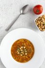 Traditional Harira soup for Ramadan in white plate with spoon and ingredients — Stock Photo