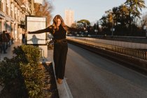 Femme élégante équilibrage sur le trottoir près de la station de métro — Photo de stock