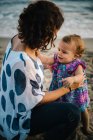 Mother playing with child on beach — Stock Photo