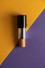 Concealer stick on modern background with geometric shapes. — Stock Photo