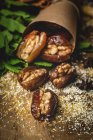 Dried dates, figs, fresh mint and cinnamon for halal snack for Ramadan wrapped in parchment — Stock Photo