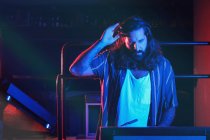 Bearded Dj man playing disco music in a club — Stock Photo