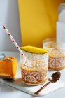 Mango and pumpkin smoothie glasses on white background — Stock Photo