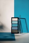 Soft blue eyeshadow palette, on geometric background. Concept product make up. — Stock Photo
