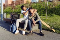 Young African American men playing on street bench — Stock Photo