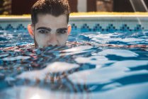Dressed man in swimming pool — Stock Photo