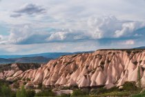 Rough stone formations in valley on sunny day in Cappadocia, Turkey — Stock Photo