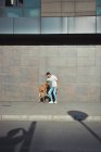 Homme courant et jouant avec son chien Boxer dans un parc — Photo de stock