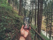 Viajero tomando fotos de amigos excursionistas mientras camina por senderos de la pintoresca zona de Dolomitas, Italia - foto de stock