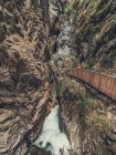 Мандрівник із захопленням спостерігає за Альпами під час прогулянки по пішохідному мосту в Доломіті (Італія). — стокове фото