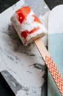 Closeup of watermelon and cream popsicle on grey and white background — Stock Photo