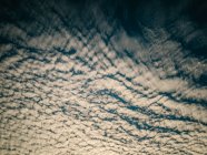 Illuminated background of beautiful calm sky with cirrus clouds at sunset — Stock Photo
