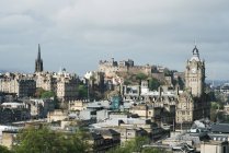 Panoramic view of old town with Gothic buildings against clouds in sunlight, Scotland — Stock Photo