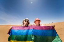 Excited plump gay couple in desert — Stock Photo