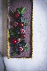 Tasty rectangular cake decorated with summer berries on white table — Stock Photo