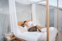 Passionate couple lying on bed in bubble hotel — Stock Photo