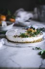Decorated tangerine cake on white marble tabletop — Stock Photo