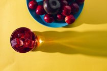 Bebida roja cerca de frutas frescas - foto de stock