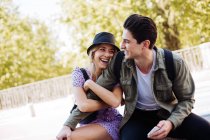 Young cheerful couple in casual clothes having fun during dating outdoors — Stock Photo