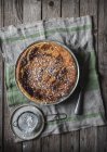 Cottage cheese baked pudding served on towel near powdered sugar on wooden table — Stock Photo