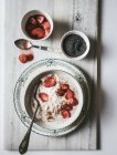 Farinha de aveia servida em tigela com morangos e sementes de chia em fundo branco — Fotografia de Stock