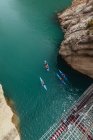 Unrecognizable people kayaking in the middle of the river — Stock Photo