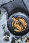 Vue du dessus du craquelin dans une assiette avec carotte et houmous de pois chiches décorés de graines — Photo de stock