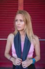 Junge blonde kaukasische Frau, die sich mit Handtuch im Nacken von einer Laufeinheit erholt — Stockfoto