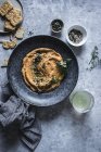 From above plate with carrot and chickpea hummus decorated with seeds — Stock Photo