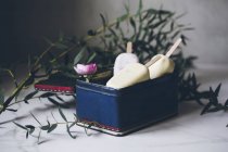 Assorted ice cream popsicles in vintage metallic box on a marble surface decorated with flowers — Stock Photo