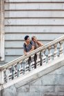 Attractive couple admiring view while standing on old stairs of historical building — Stock Photo