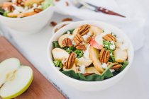 Served bowls with apple and pecan salad on table — Stock Photo