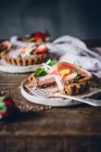 From above portions of delicious strawberry and citrus cakes served on decorated wooden table — Stock Photo